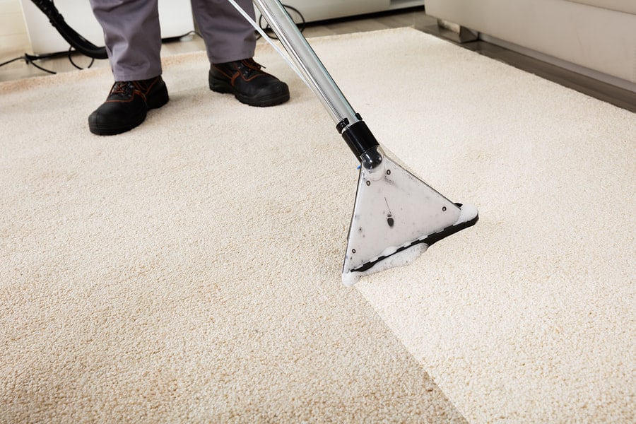 man cleaning a carpet
